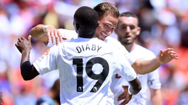 Matty Cash of Aston Villa celebrates with teammate Moussa Diaby
