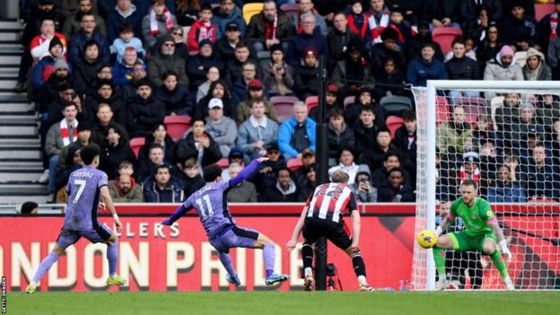 Liverpool forward Mohamed Salah scores from low against Brentford