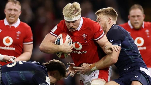 Aaron Wainwright, who has played in two World Cups, charges through the Scotland defence