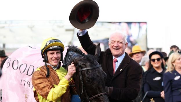 Paul Townend poses alongside trainer Willie Mullins after winning the Cheltenham Gold Cup