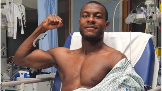 Evan Ndicka poses for a photo in hospital