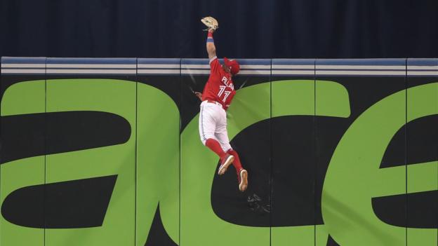 TORONTO, ON - JULY 1: Kevin Pillar #11 of the Toronto Blue Jays climbs the wall and catches a fly ball hit by Nicholas Castellanos #9 of the Detroit Tigers in the ninth inning during MLB game action at Rogers Centre on July 1, 2018 in Toronto, Canada. (Photo by Tom Szczerbowski/Getty Images)