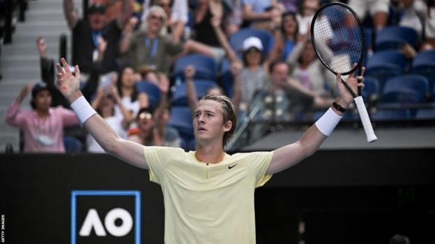 Sebastian Korda raises his arms