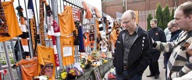 Justine's brother Stephen, the Dundee United chairman, visits the tributes to his father left by fans at Tannadice