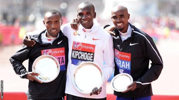 Second placed Tola Shura Kitata of Ethiopia, winner Eliud Kipchoge of Kenya and third placed Mo Farah of Great Britain