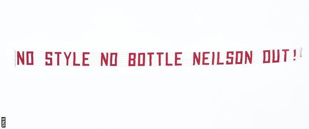 A banner flown over Tynecastle which reads 'No style no bottle Neilson out