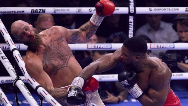 Anthony Joshua knocks down Robert Helenius during their heavyweight fight