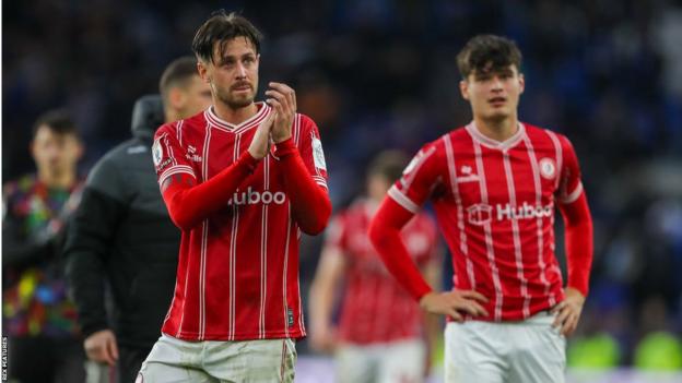 Jamie Knight-Lebel (right) stands on the pitch after Bristol City's game with Cardiff