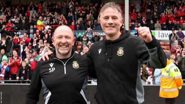 Phil Parkinson (right) and his assistant Steve Parkin celebrate their promotion in front of fans.