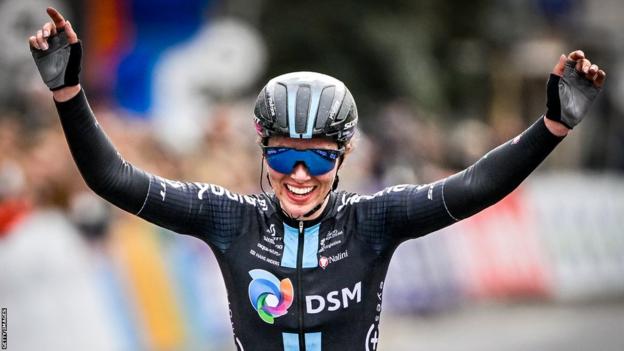 British cyclist Pfeiffer Georgi smiles and puts her arms up as she crosses the line to win Classic Brugge-De Panne