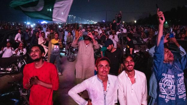  Hopeful cricket fans in Karachi, Pakistan watch their team play Australia on a big screen in the T20 World Cup semi-finals