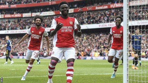 Bukayo Saka celebrates after scoring a penalty against Manchester United
