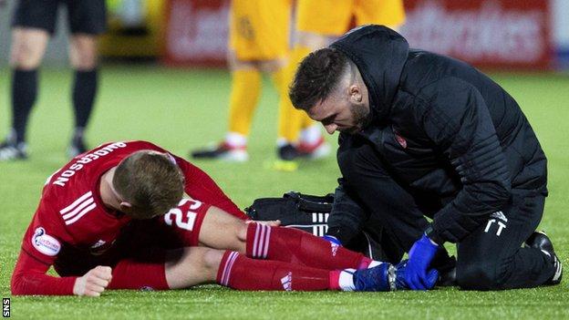 Aberdeen's Bruce Anderson receives treatment against Livingston