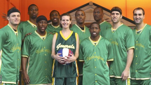 The Washington Generals pose in training tops along with a journalist the n