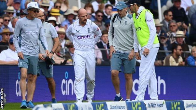 England spinner Jack Leach leaves the field after injuring himself while fielding near the boundary