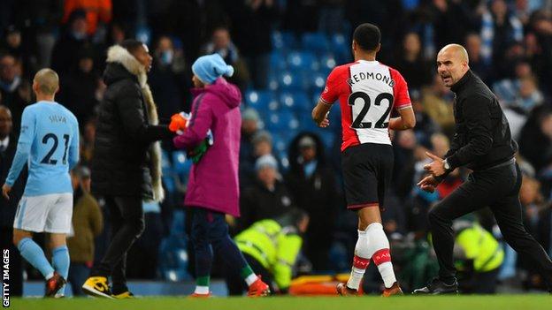 Manchester City manager Pep Guardiola confronts Southampton's Nathan Redmond