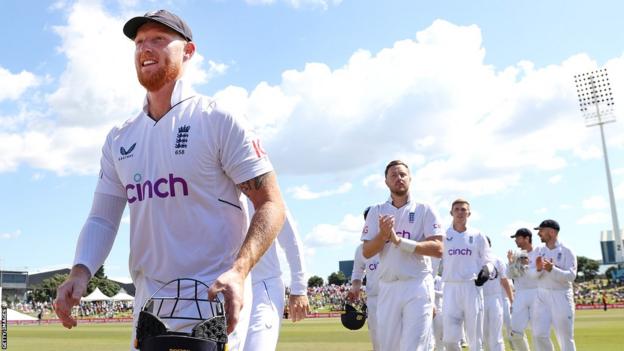 England captain Ben Stokes (left) leads his team off the field after beating New Zealand