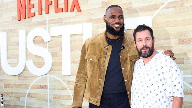 Cast members LeBron James and Adam Sandler attend a premiere for the film Hustle