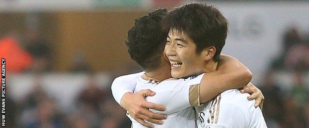 Swansea midfielder Ki Sung-yueng (right) celebrates his goal against West Brom with Neil Taylor