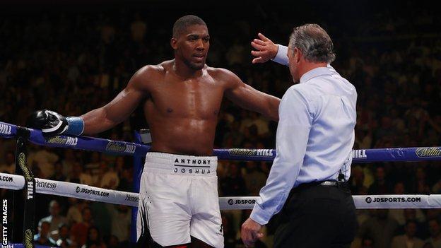 Anthony Joshua is stopped by the referee