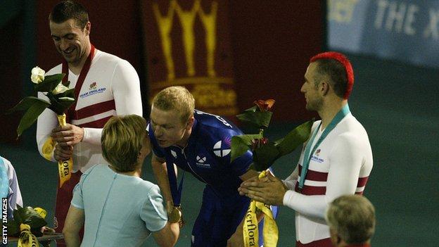 Sir Chris Hoy is presented with his gold medal in Manchester
