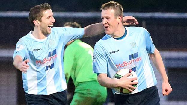 Allan Jenkins has the match ball safely in the grasp as he celebrates completing his hat-trick in Ballymena's 4-2 victory over bottom club Warrenpoint Town