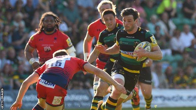Ben Foden of Northampton Saints is tackled by Chris Pennell of Worcester Warriors
