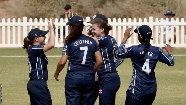 Kathryn Bryce celebrates after one of her three wickets that skittled France