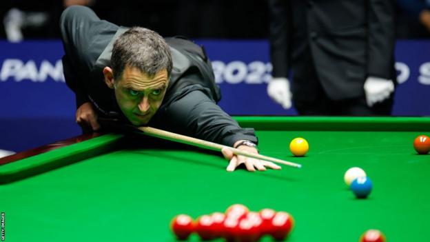 Ronnie O'Sullivan plays a shot