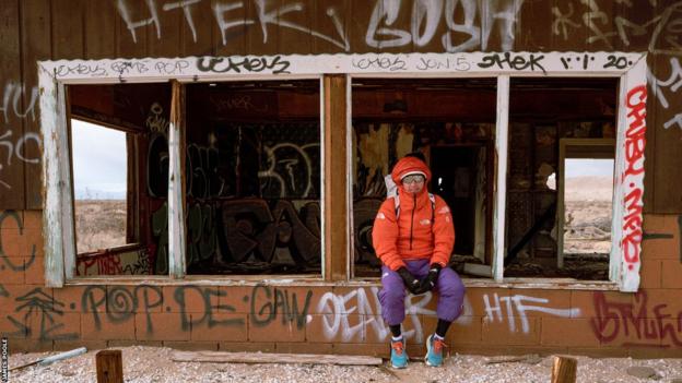 James Poole sitting outside a derelict building on his 2023 The Speed Project run