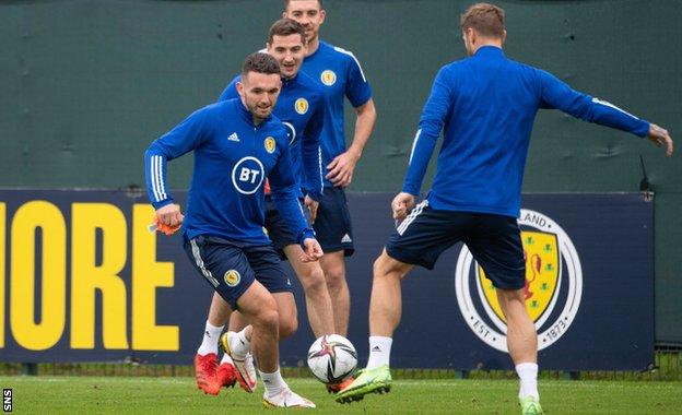 John McGinn (left) has rejoined training