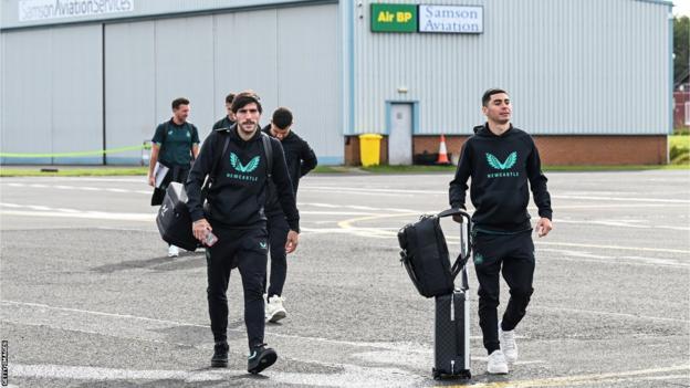 Newcastle players walk to their plane