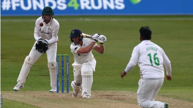 Glamorgan's Chris Cooke drives a ball past Rehan Ahmed of Leicestershire