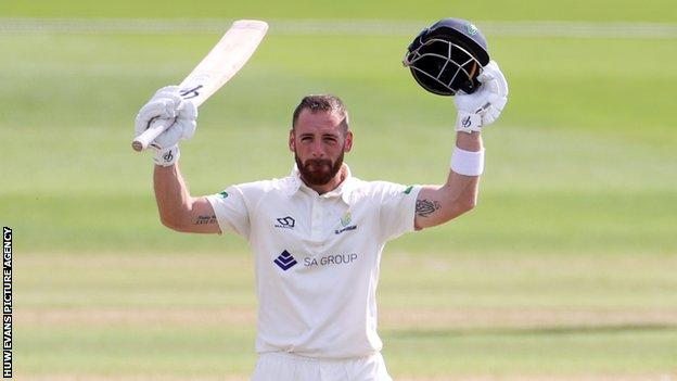 David Lloyd celebrates reaching his triple century