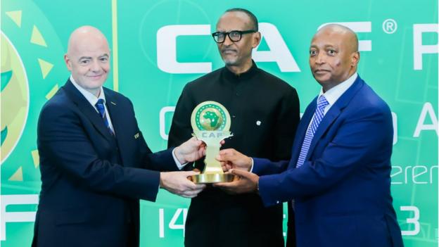 FIFA President Gianni Infantino (left) and African Football Confederation President Patrice Motsepe (right) giving President of Rwanda Paul Kagame (middle) an award for an outstanding achievement award at the 73rd FIFA Congress, in Kigali, Rwanda on 13rd March 2023.