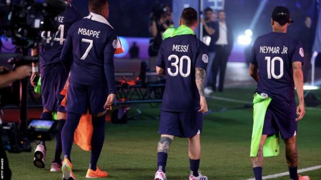Kylian Mbappe, Lionel Messi and Neymar walk away during a PSG match
