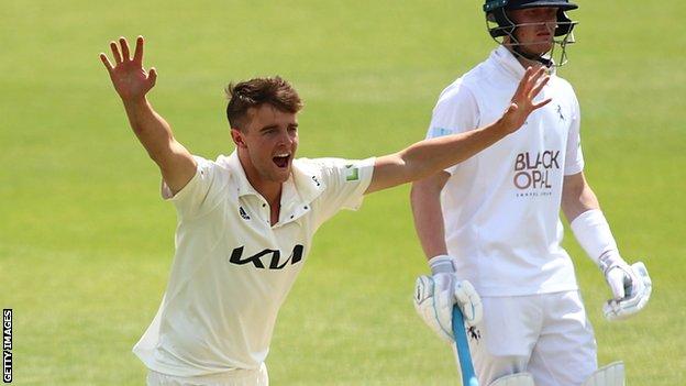 Tom Lawes takes a wicket for Surrey