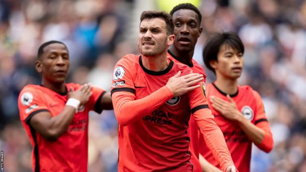 Brighton players, led by Pascal Gross, protest against a handball decision