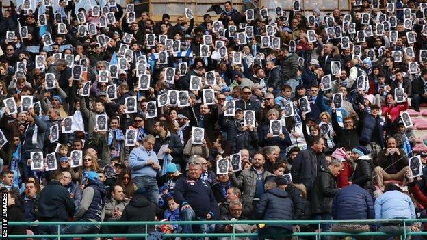 Fans wear Kalidou Koulibaly masks at Napoli's Serie A game against Carpi