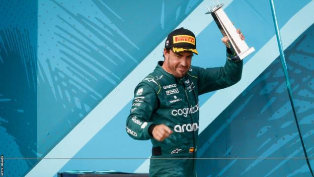 Fernando Alonso celebrates on the podium after finishing third at the Miami Grand Prix