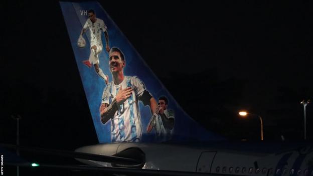 A picture of Lionel Messi on the tail of a plane