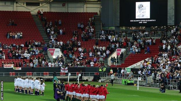 Players and fans observe a minute's silence