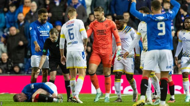 Rangers and St Johnstone players with referee Alan Muir