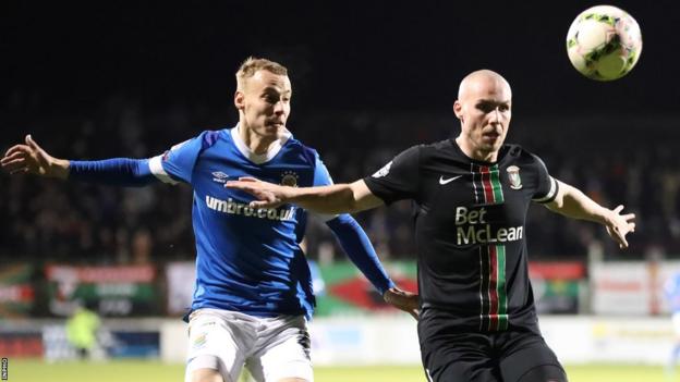 Eetu Vertainen and Luke McCullough vie for possession during Linfield's 3-0 League Cup semi-final win over Glentoran