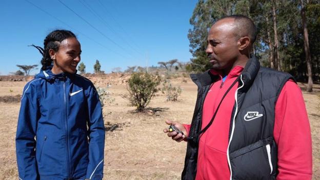 Gudaf Tsegay in training gear with her coach/husband