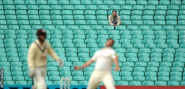 A lone spectator looks on during a County Championship match between Surrey and Nottinghamshire at the Oval in 2016