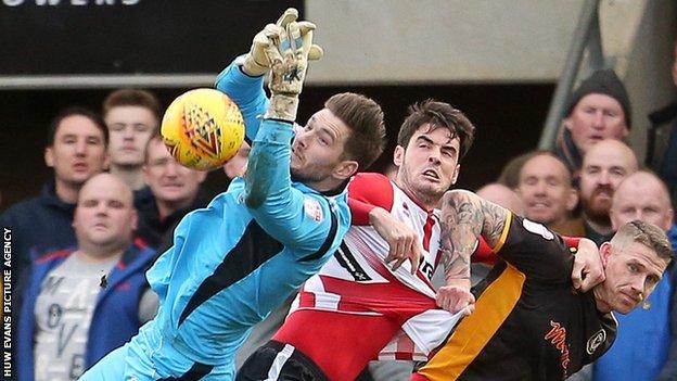 Newport County's Joe Day saves a goal-bound effort against Cheltenham Town