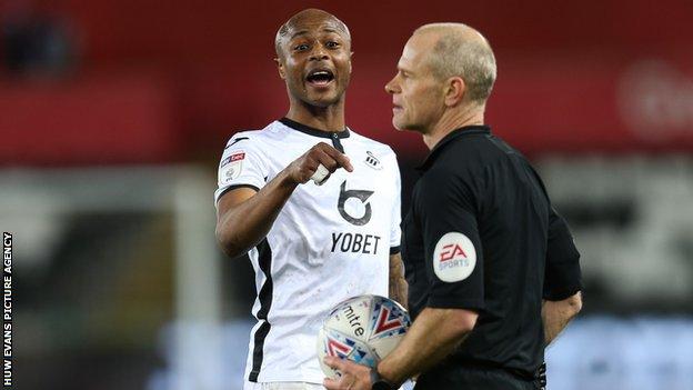 Swansea forward Andre Ayew argues his point with referee Andy Woolmer during a previous game against Queens Park Rangers