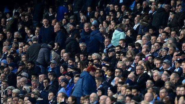 Manchester City supporters leaving Etihad Stadium