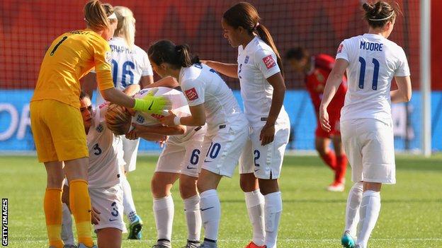 England players console Laura Bassett after she scored an own goal against Japan